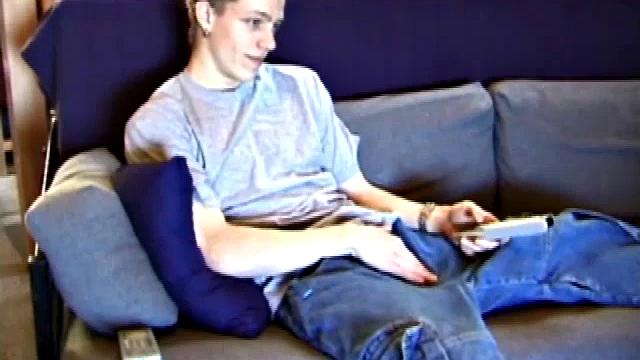 Young Shane relaxes on the sofa while watching a porn video and gets totally into himself. He delivers a nice long stroke show, before shooting onto his t-shirt.