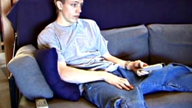 Young Shane relaxes on the sofa while watching a porn video and gets totally into himself. He delivers a nice long stroke show, before shooting onto his t-shirt.