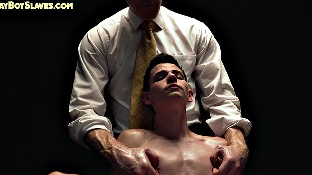 Dominant suited DILF jerks cock of skinny oiled twink