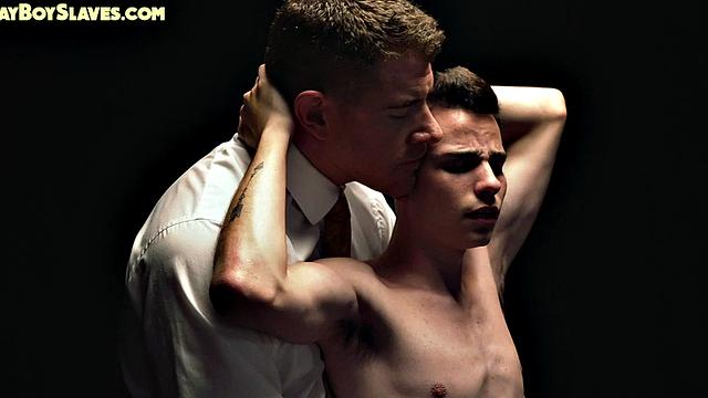 Dominant suited DILF jerks cock of skinny oiled twink