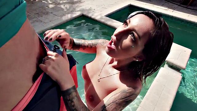 Tattooed babe gags on big dick and takes it doggystyle in the pool