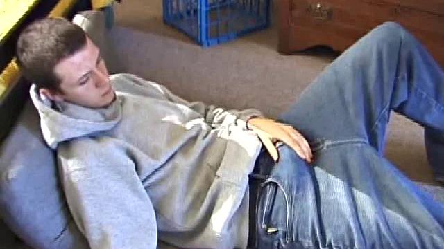 After using the remote to cue up a porn video, young Derek massages his crotch and wakes up his monster. Once the clothes are off, he starts to stroke and it doesn't take long for Derek to cum all over his hairy tummy.