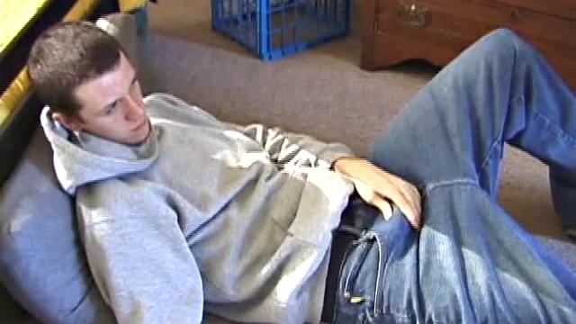 After using the remote to cue up a porn video, young Derek massages his crotch and wakes up his monster. Once the clothes are off, he starts to stroke and it doesn't take long for Derek to cum all over his hairy tummy.