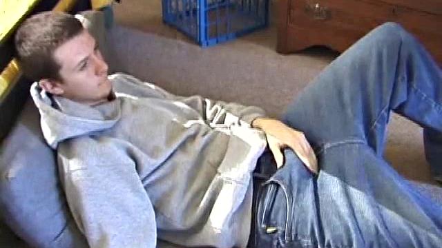 After using the remote to cue up a porn video, young Derek massages his crotch and wakes up his monster. Once the clothes are off, he starts to stroke and it doesn't take long for Derek to cum all over his hairy tummy.