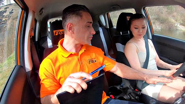 Asian driving learner throating and riding instructor in car
