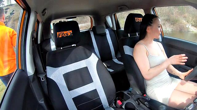 Asian driving learner throating and riding instructor in car