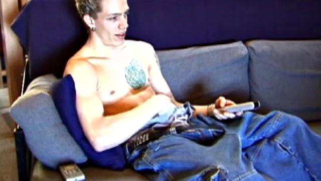 Shane relaxes on the sofa, while watching a porn video and gets totally into himself. He works his lubed up cock with determination and pumps out a big cum gusher.