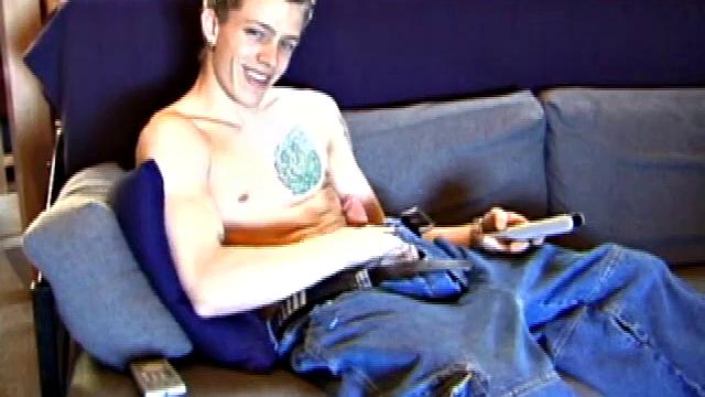 Shane relaxes on the sofa, while watching a porn video and gets totally into himself. He works his lubed up cock with determination and pumps out a big cum gusher.