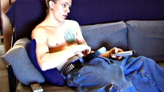 Shane relaxes on the sofa, while watching a porn video and gets totally into himself. He works his lubed up cock with determination and pumps out a big cum gusher.