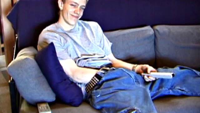 Shane relaxes on the sofa, while watching a porn video and gets totally into himself. He works his lubed up cock with determination and pumps out a big cum gusher.