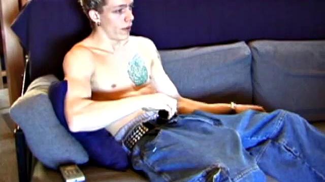 Shane relaxes on the sofa, while watching a porn video and gets totally into himself. He works his lubed up cock with determination and pumps out a big cum gusher.