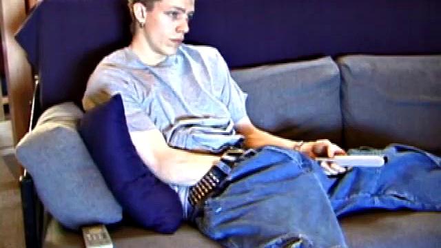 Shane relaxes on the sofa, while watching a porn video and gets totally into himself. He works his lubed up cock with determination and pumps out a big cum gusher.