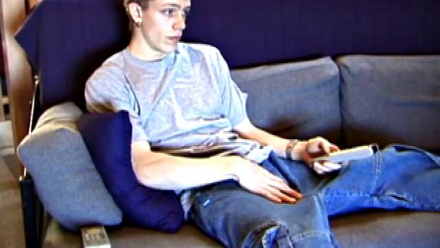 Shane relaxes on the sofa, while watching a porn video and gets totally into himself. He works his lubed up cock with determination and pumps out a big cum gusher.