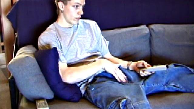 Shane relaxes on the sofa, while watching a porn video and gets totally into himself. He works his lubed up cock with determination and pumps out a big cum gusher.