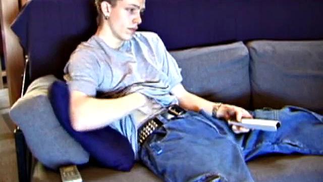 Shane relaxes on the sofa, while watching a porn video and gets totally into himself. He works his lubed up cock with determination and pumps out a big cum gusher.