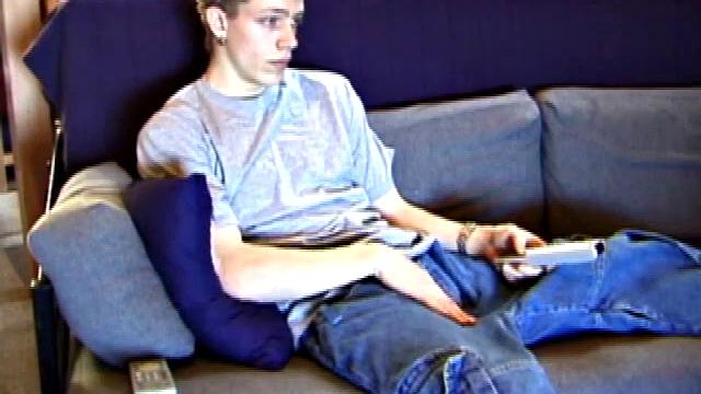 Shane relaxes on the sofa, while watching a porn video and gets totally into himself. He works his lubed up cock with determination and pumps out a big cum gusher.