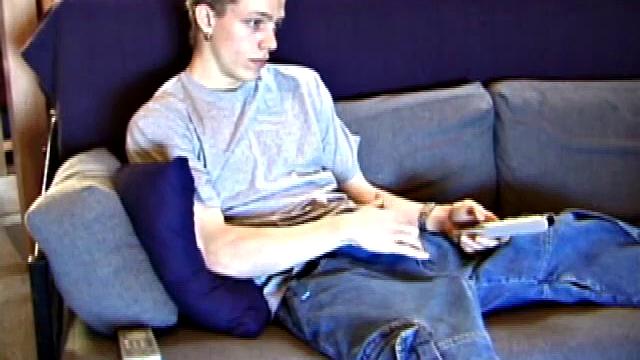 Shane relaxes on the sofa, while watching a porn video and gets totally into himself. He works his lubed up cock with determination and pumps out a big cum gusher.