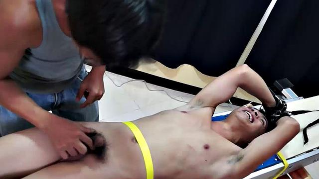 Diamond collectors have captured a thief who's been stealing diamonds from them. They've strapped him down on a rack and intend to tickle the cute young Asian boy until he breaks. They've got all day if necessary.