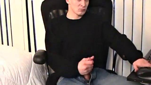 Seated in front of his computer, Darrell works his cock, pulls it out, jerks off with determination, grabs a wine glass, and dumps his warm cum into it.