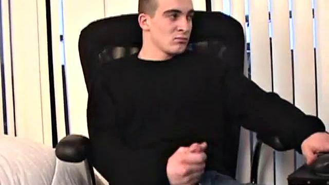 Seated in front of his computer, Darrell works his cock, pulls it out, jerks off with determination, grabs a wine glass, and dumps his warm cum into it.