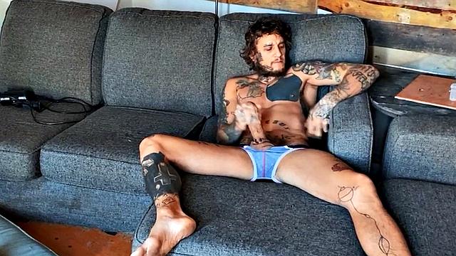 Inked stud fingering tight asshole while jerking