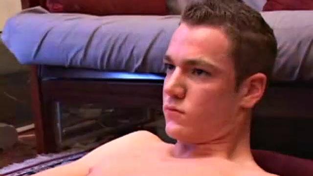 Brayden jacks off on the sofa, while he watches a porn video, and then moves to the floor so he can suck on the head of his dick. After a good stroking, Brayden shoots his cum load onto his tongue and face.