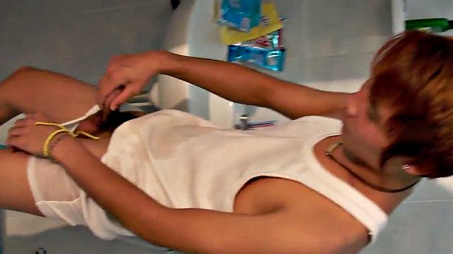Asian pissing guy strokes cock and cums in solo action