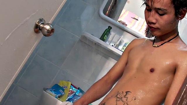 Asian pissing guy strokes cock and cums in solo action