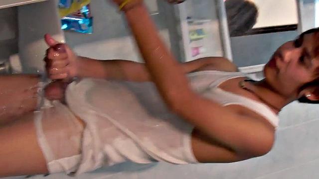 Asian pissing guy strokes cock and cums in solo action