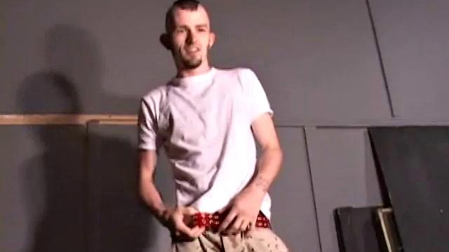 Nick Stevens with facial hair and piercings strokes cock to porn, keeps the t-shirt on