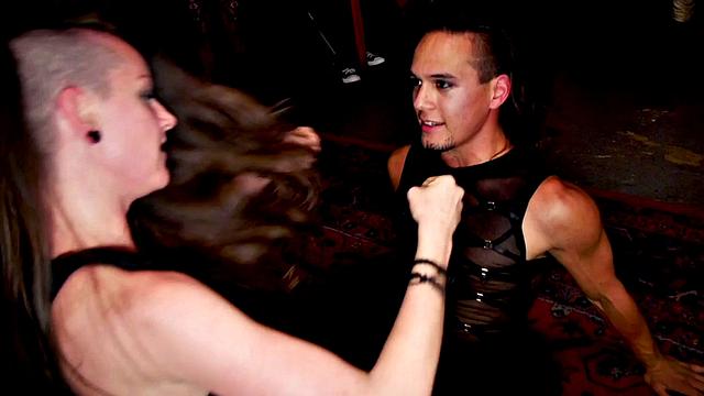 Public BDSM slut with toy in ass gets whipped by two masters