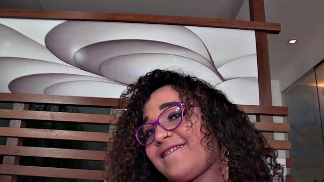 Curly-haired Latina Tgirl flaunts her tits before teasing solo with glasses on