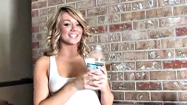 Sexy blonde dripping wet as she soaks her shirt