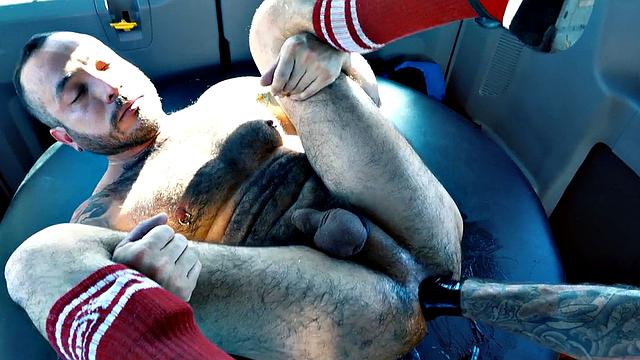 Hairy fisting-loving DILF treated in van by mature in gloves