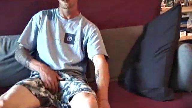Young amateur Brandon reclines on the sofa and pulls off his pants. While watching a video, he rubs his cock hard and fingers his ass.