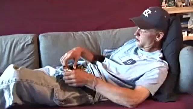 Young amateur Brandon reclines on the sofa and pulls off his pants. While watching a video, he rubs his cock hard and fingers his ass.