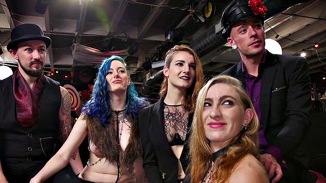 Blonde dominas fist their bound lesbian friends in a wild public orgy