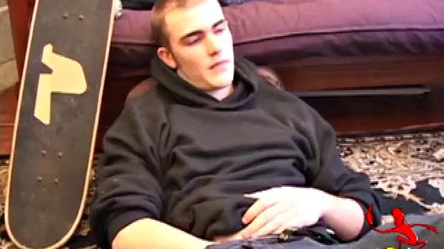 After coming back from skateboarding, Christian Wilde gets a stiff one thru his pants and pulls it out. Some double-handed stroking finally sends a cum gusher onto his chest.