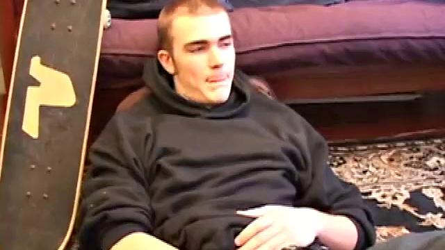 After coming back from skateboarding, Christian Wilde gets a stiff one thru his pants and pulls it out. Some double-handed stroking finally sends a cum gusher onto his chest.
