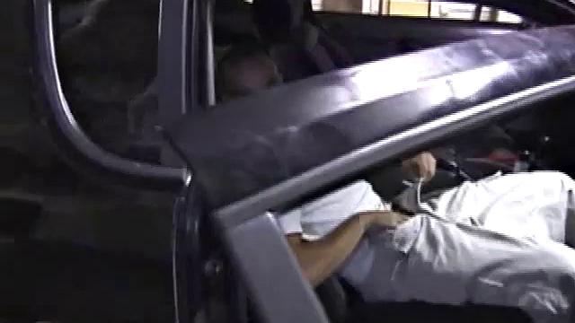 Bradley Shaw finds the passenger seat of a black sedan for some private time. Since the car is parked in the garage, Bradley has positioned a TV with VCR so his porn can keep him stimulated.