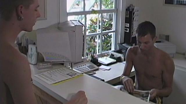 We look in on 21 year old Joey Landis, who is working the front desk when 19 year old Blake Ashton comes to say hello. When Blake leaves, he starts flirting with Joey through the window. Joey responds by stripping down and stroking his big hard dick.