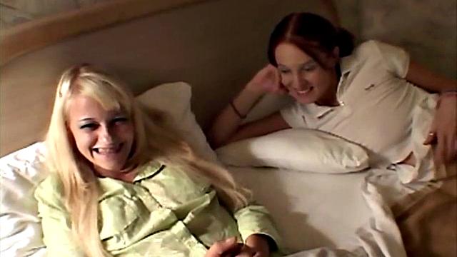 Watch twin lesbian cuties kiss and lick each other's bald pussies in the bedroom