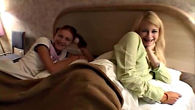 Watch twin lesbian cuties kiss and lick each other's bald pussies in the bedroom