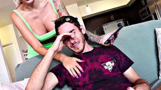 A tattooed MILF dominate and jerk off her lucky guy on the couch