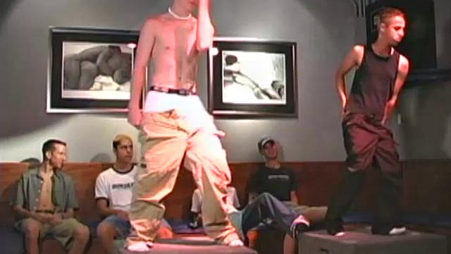 Evan and Zachary are stripping naked and dancing at the local bar, surrounded by fans.