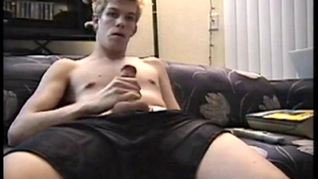 While watching porn on the sofa, Jason Baltimore pulls on his fat dick through his black boxers, with the camera right between his legs. Underwear off, he fingers his ass, with his feet in our face.