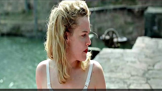 Blonde celebrity Riley Keough gets naughty in public with a topless bra-clad scene