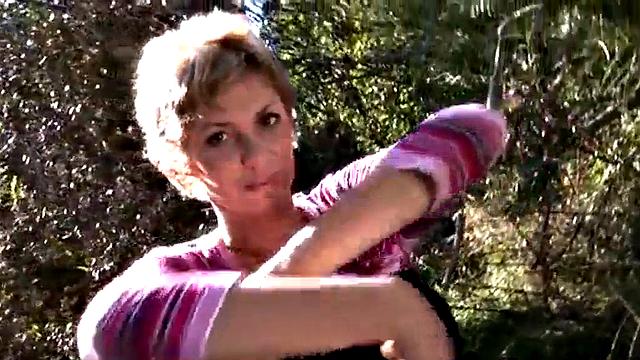 Busty blonde MILF gets naked outdoors