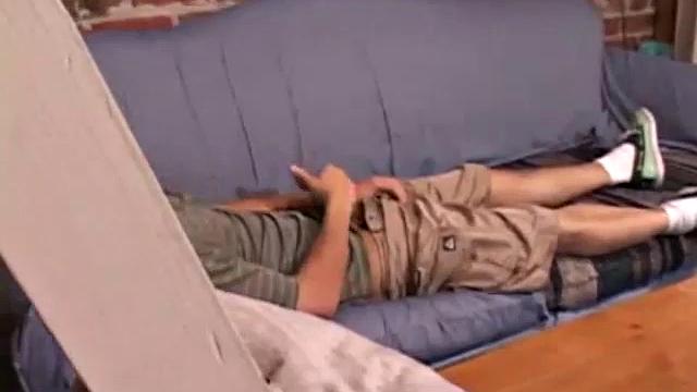 While T.J. Kummings strokes his hard cock on the sofa, he lets a helping hand plug up his butt with dildos. Butt play turns to cock play, as he gets a hand job and blows a big warm load.