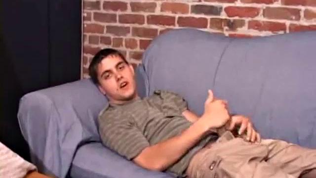 While T.J. Kummings strokes his hard cock on the sofa, he lets a helping hand plug up his butt with dildos. Butt play turns to cock play, as he gets a hand job and blows a big warm load.